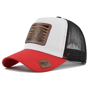 Detail of the lion leather patch and USA map tag on a tri-color mesh trucker baseball cap