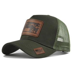 Detail of army green trucker hat with breathable mesh and leather patch showing cow graphics