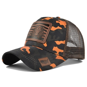 Detail view of orange camouflage trucker hat with lion leather patch and mesh back