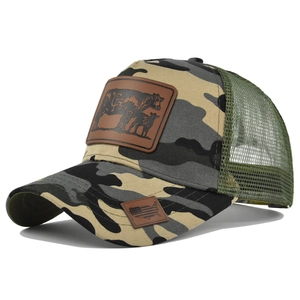 Close-up of camouflage trucker hat featuring leather cow patch and breathable green mesh