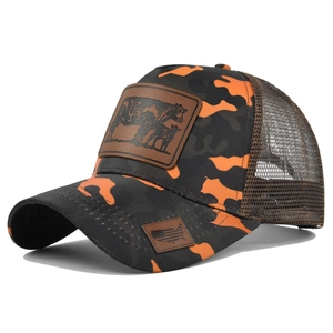 Detail of leather patch with cow design on orange camouflage mesh trucker cap