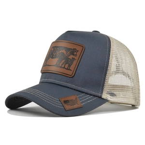 Close-up of trucker hat with cow leather patch and american flag map embroidery details