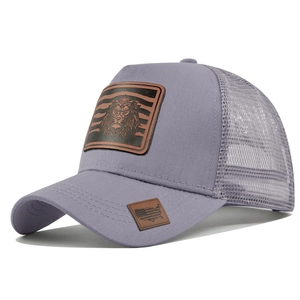 Close-up of a grey mesh trucker hat with a lion patch and side leather detail