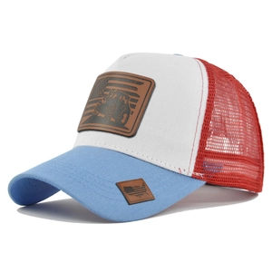 Detail of red white and blue trucker hat with vintage tractor leather patch