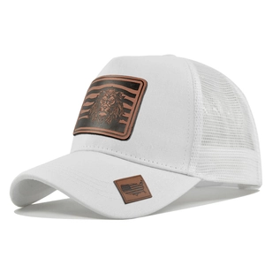 Detailed close-up of white mesh trucker hat with embossed lion head leather patch