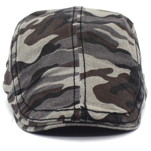 Detail of camouflage newsboy cap featuring black double stitching and cotton fabric