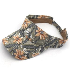 Detailed top view showing the orange floral print and brown sweatband on the sun visor hat