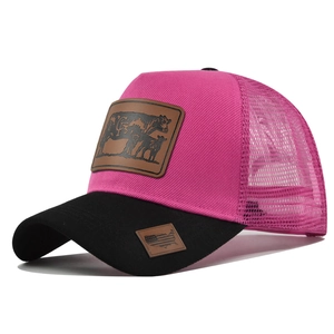 Detail of rose red trucker hat featuring leather patches and breathable mesh back