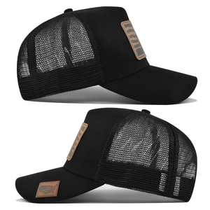 Detail view of black mesh trucker hat with synthetic leather patch and side map embroidery