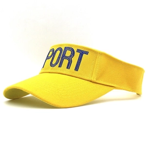 Detail view of the yellow sun visor hat with blue SPORT embroidery and curved brim