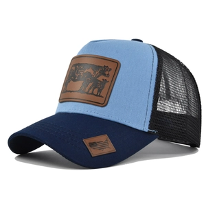 Blue trucker hat with cow leather patch and breathable mesh back in vintage style