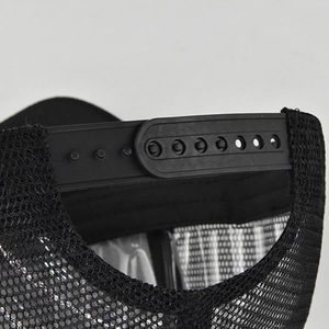 Detail view of the adjustable snapback closure and breathable mesh on black trucker hat