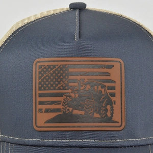 Close-up of leather patch with Jeep and US flag on navy mesh trucker hat detail