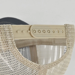 Detailed close-up of adjustable snapback closure and breathable mesh on trucker hat