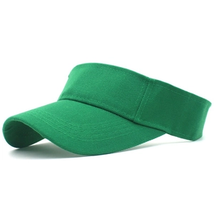 Detail view of bright green cotton visor hat with reinforced stitching on the curved brim