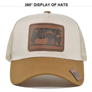 Breathable mesh trucker hat in cream and khaki with cow silhouette leather patch