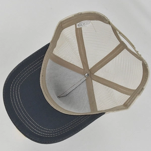 Internal view of the trucker hat showing the breathable mesh and material care label