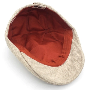 Beige cotton linen flat cap with vibrant orange lining and adjustable back strap