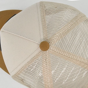 Detail view of the breathable mesh structure and neat stitching on a tri-color trucker hat