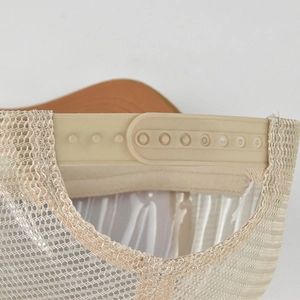 Detail of adjustable snapback closure and breathable mesh fabric on a trucker baseball cap