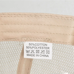 Detail shot of the 50% cotton 50% polyester wash label and breathable mesh on a cap