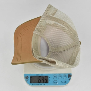 Weight measurement detail showing the breathable mesh baseball cap at 64.5 grams