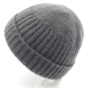 Detailed close-up of dark grey knitted beanie showing fine ribbed wool texture and cuffed hem