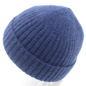 Detailed view of dark blue ribbed knit beanie with thick textured stitching and material