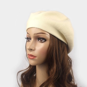 Detail of beige knit wool beret showing premium fine-knit texture and soft warm fabric