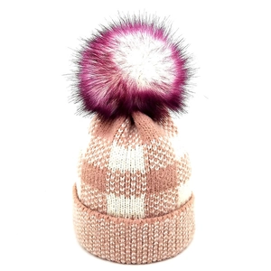 Close-up of pink plaid knit beanie with a large purple gradient faux fur pom pom detail
