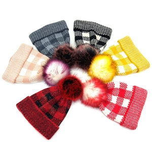 Women's plaid knit beanie with faux fur pom pom in multiple colors for winter warmth