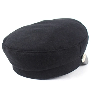 Close-up of a black fisherman cap featuring thick wool fabric and a silver side button detail
