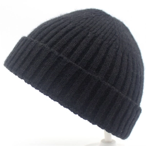 Detail showing classic vertical ribbed knit texture and wide cuff on black beanie hat