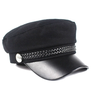 Detailed macro view of the black wool newsboy hat featuring leather brim and silver button