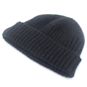 Close-up of black chunky knit beanie featuring a soft texture and elastic ribbed cuff