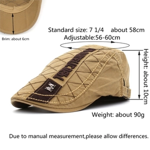 Detail view of khaki flat cap showing embroidered side panels and adjustable metal buckle