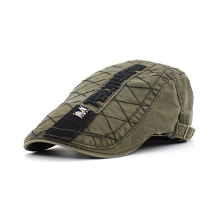Detail of army green washed cotton cap with quilted texture and metal crown logo