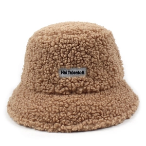 Close-up of the plush faux shearling texture and logo patch on the khaki bucket hat