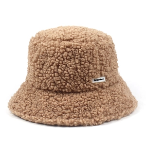 Detail of brown sherpa fleece bucket hat featuring white Sei Carina Y woven label