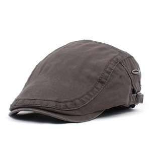 Detail of adjustable metal buckle and side stitching on dark brown newsboy cap