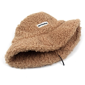 Plush brown sherpa bucket hat for women with brand label and warm teddy fleece texture