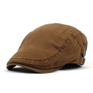 Close-up of brown canvas flat cap showing side embroidery and metal adjustment buckle