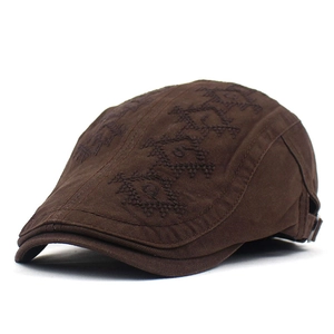 Detail of coffee brown cotton canvas beret with geometric embroidery and adjustable metal buckle