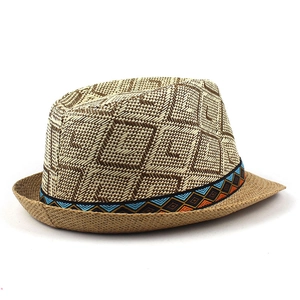 Close-up of woven straw fedora hat featuring brown diamond pattern and ethnic ribbon