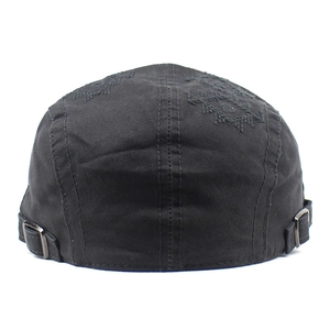 Detail of leaf embroidery on black canvas cadet cap with adjustable metal side buckles