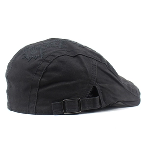 Detail of black cotton ivy cap featuring diamond embroidery and metal adjustable strap