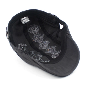 Internal view of the black cotton beret showing the inner stitching and wash label detail