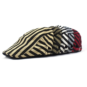 Detail of five striped cotton linen newsboy caps showing diverse colors and metal buckles