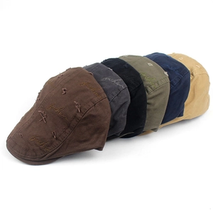 Detailed stack of distressed cotton berets with fashion embroidery in multiple colors