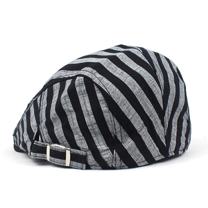Close-up of adjustable metal buckle and striped texture on a cotton linen newsboy cap